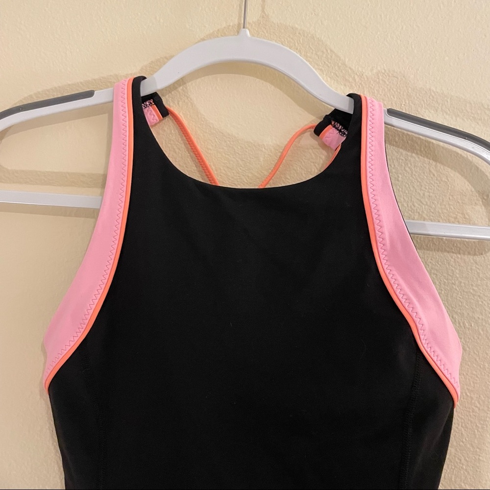 Lululemon black high neck tank top with bright pink and orange detail. Size 6